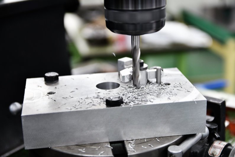 CNC machine drilling aluminum block