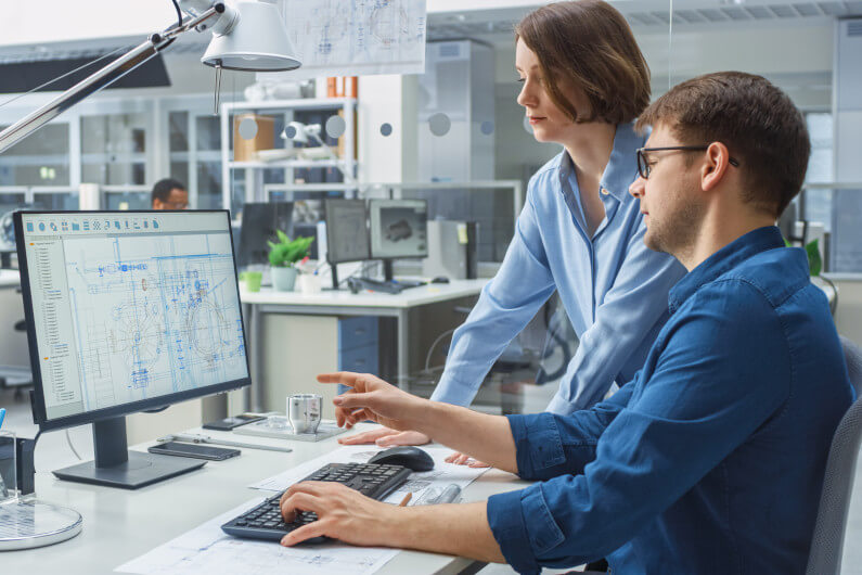 Engineer and project manager discussing a design