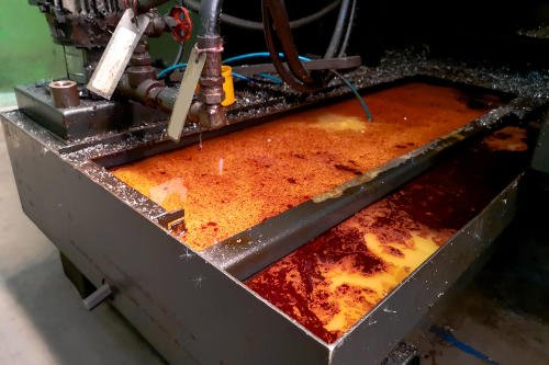 Coolant tank dirty with oil and sludge
