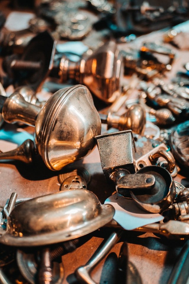 Brass vs. bronze - brass door knob and caster wheel lot