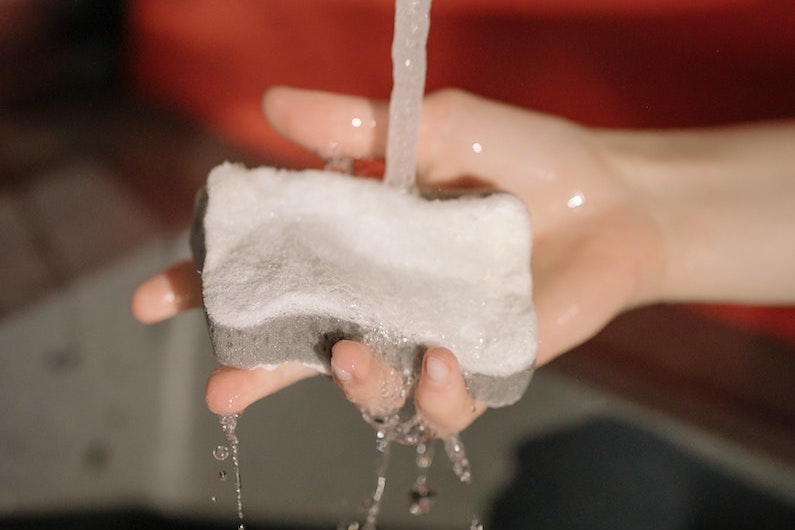 Holding a sponge under running water