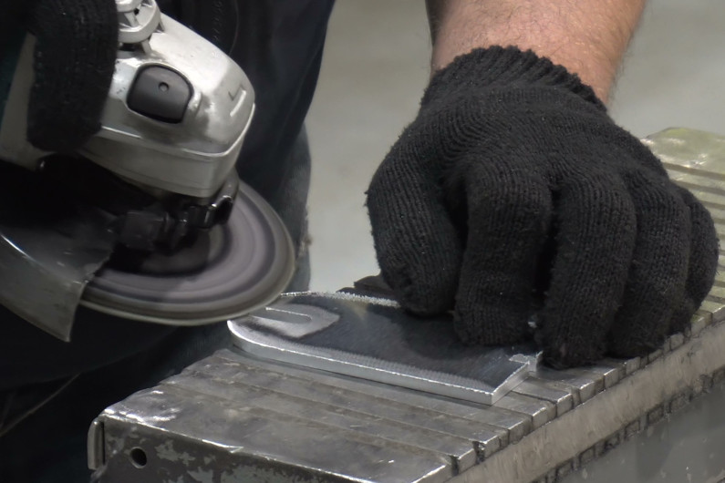 Man deburring a metal part